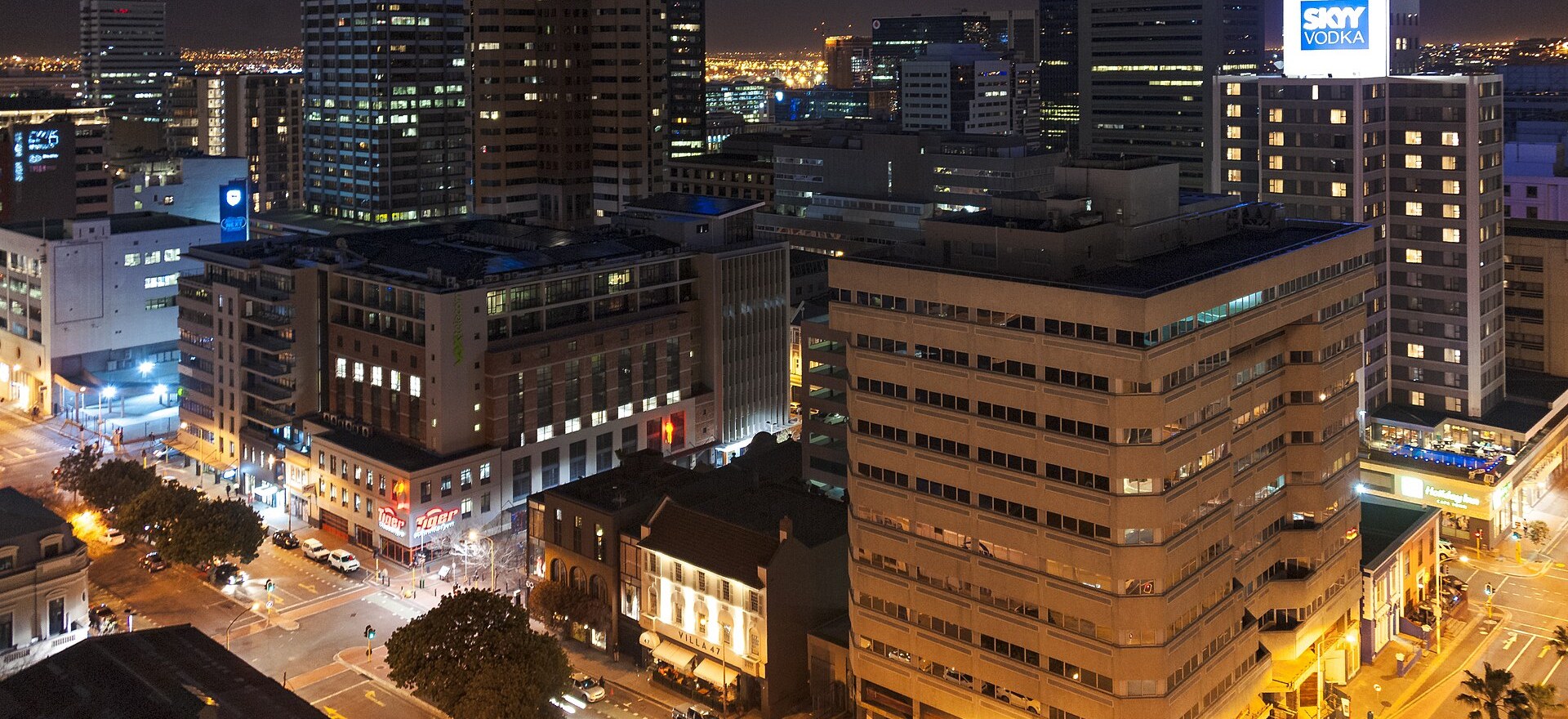 Cape Town CBD streets and office towers lit up at night, seen from a rooftop